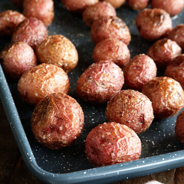 Roasted New Potatoes on baking pan close photo