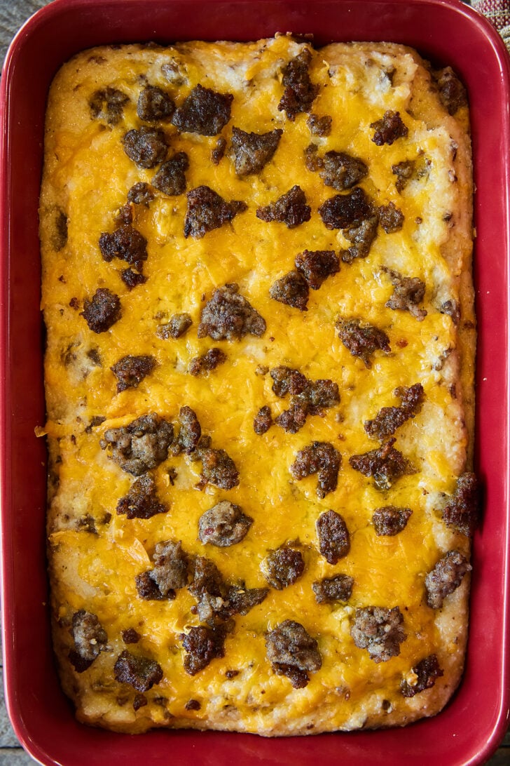 Grits and Sausage Casserole in a red baking dish.
