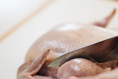 Cutting chicken.