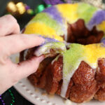 Taking a pinch of King Cake Pull Apart with fingers
