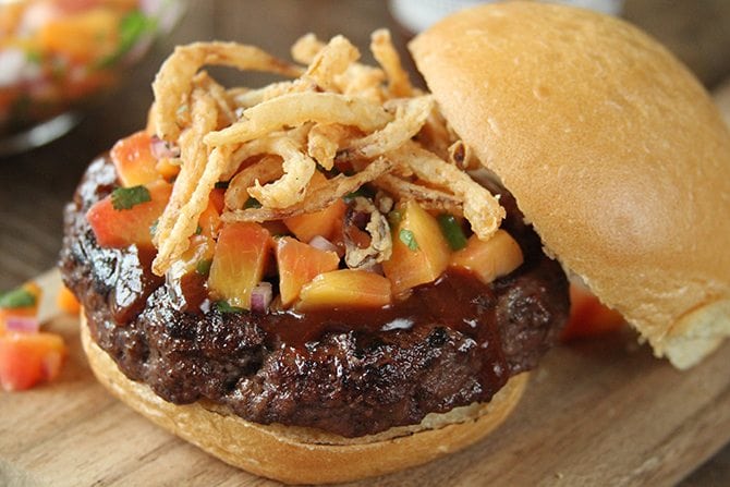 Top this sweet and sticky pork burger with homemade peach salsa for an unexpected kick!  