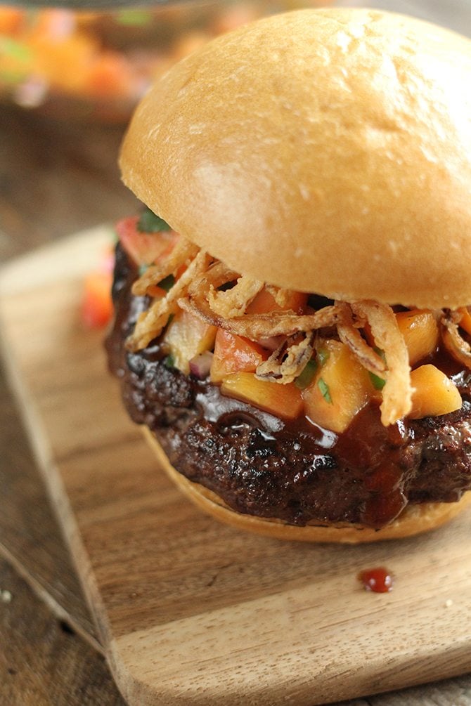 Top this sweet and sticky pork burger with homemade peach salsa for an unexpected kick!  