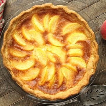 This Peach Chess Pie combines all the flavor of delicious peach cobbler in a decadent custard pie!