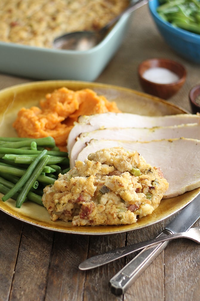 Creole Cornbread Dressing served with sliced turkey and vegetables
