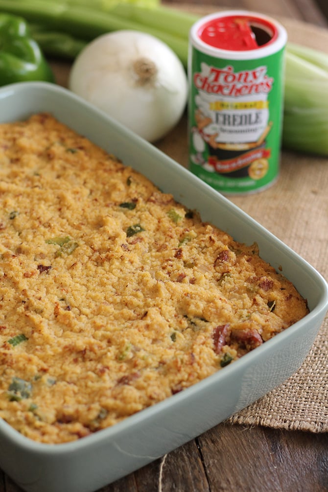 Creole Cornbread Dressing in  baking pan with spices in background
