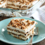 Slice of Milk and Cookies Icebox cake on green dish