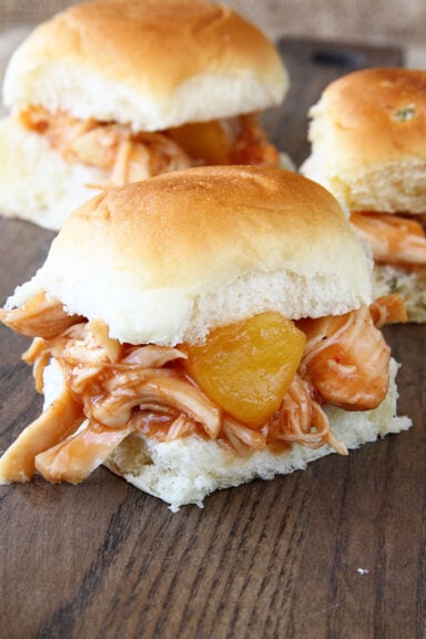 Slow Cooker Pineapple Chicken Sliders on a board.