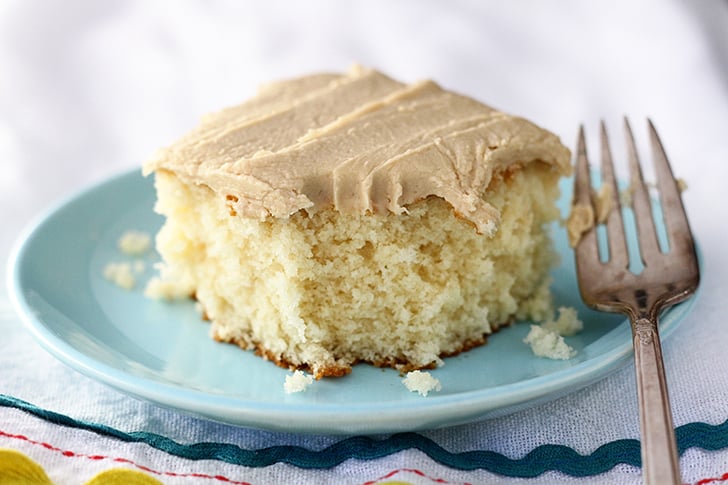 Easy Caramel Sheet Cake on a blue plate. bite missing.