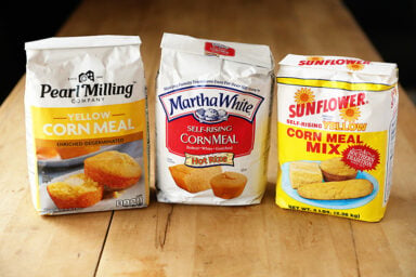 Three bags of different types of cornmeal.