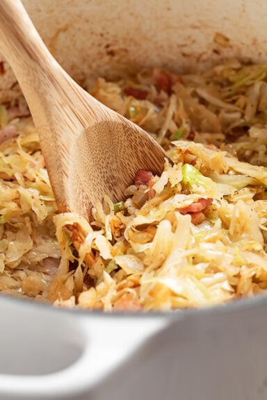 Shortcut Skillet Cabbage and Bacon Served with a Spoon.